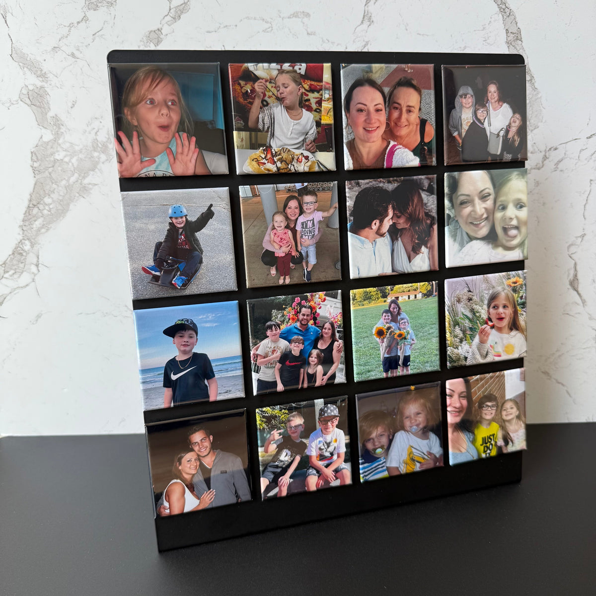 Collage of personal photo fridge magnets on a magnetic tabletop frame