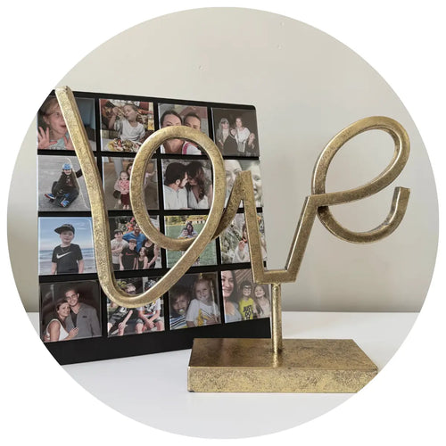 Custom photo magnet collage featuring family photos, shown with a gold love sculpture as a personalized keepsake and decorative magnetic display.