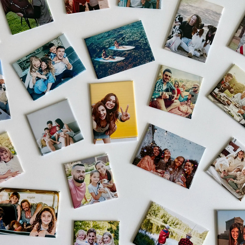 Colorful custom photo magnets by Ink and Magnets scattered on white, capturing beach trips, puppy love, family, and celebrations as magnetic keepsakes.