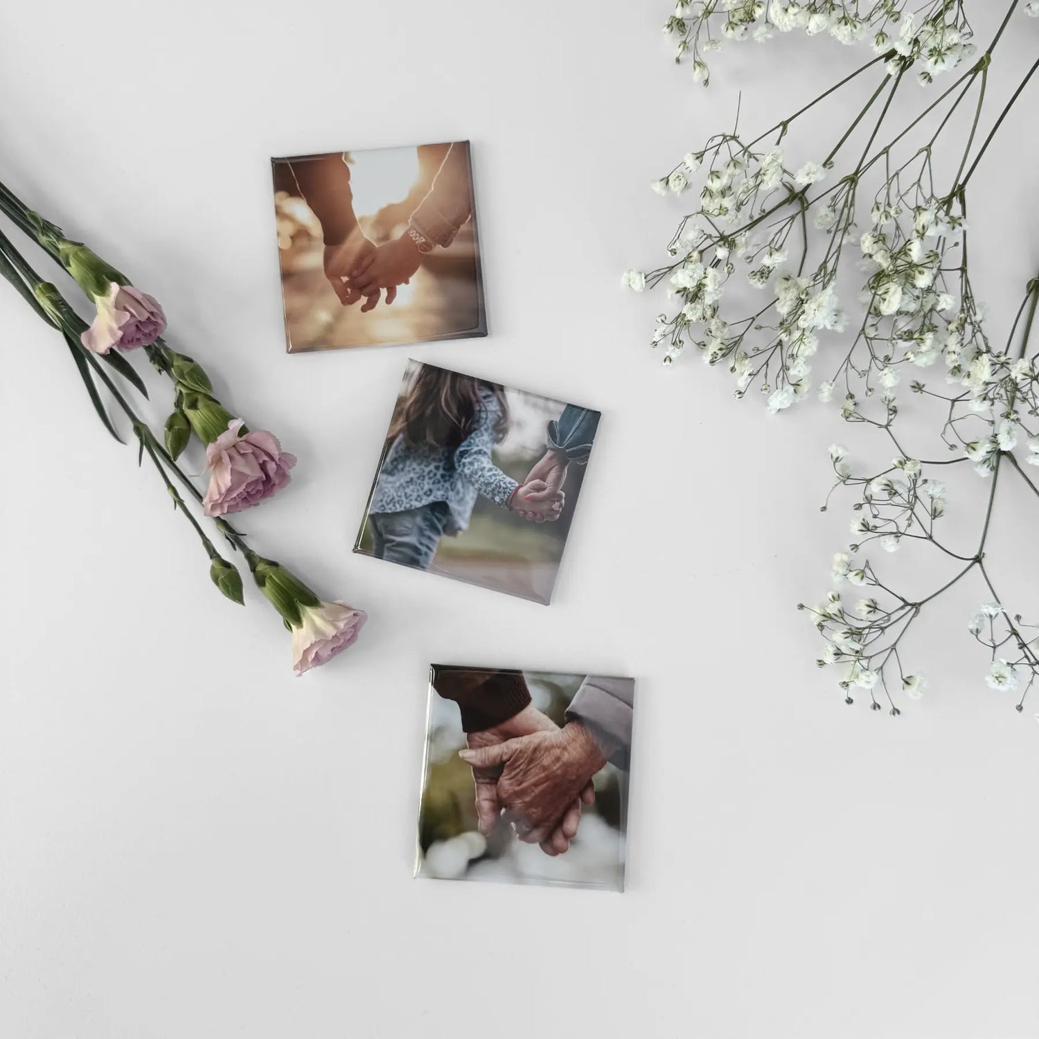 Custom photo magnets featuring real family moments, styled with flowers as a sentimental magnetic photo display and personalized keepsake gift.