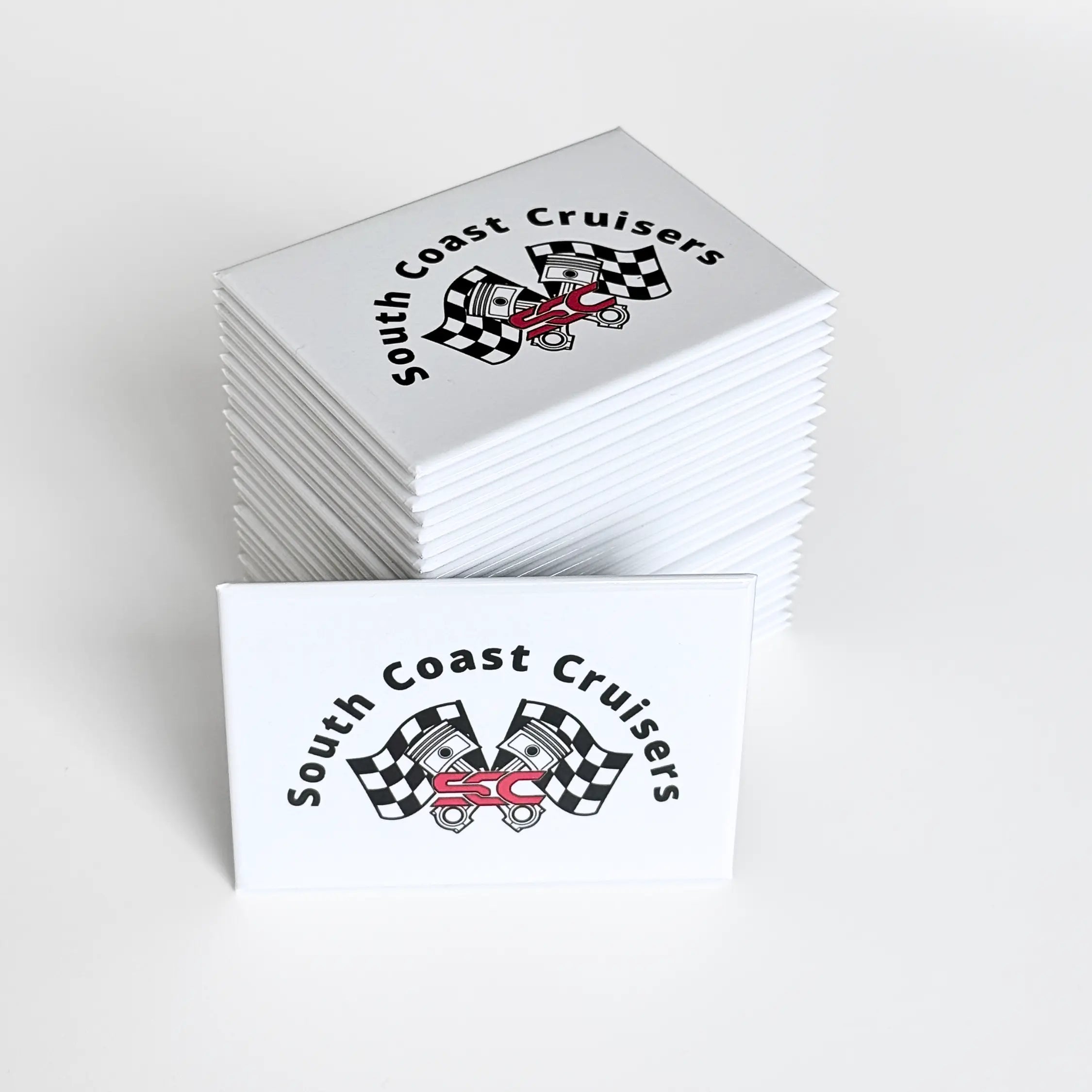 Custom logo magnets stacked together, showing promotional business magnets designed for branding, events, and memorable marketing giveaways.