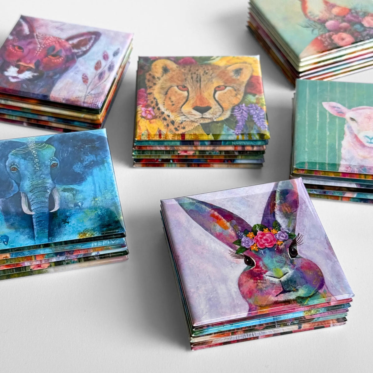 Collection of original artwork magnets featuring professional grade prints, vibrant colors, and made into 2.5" square keepsake button magnets. Mini art prints made magnetic with professional media perfect for resale and gifting.