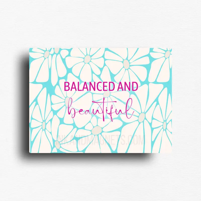 Affirmation quote fridge magnet featuring the message "Balanced and Beautiful" with retro floral artwork, vibrant pink typography, and cheerful turquoise daisy pattern. Uplifting décor for refrigerators, lockers, office file cabinets, and magnetic boards.