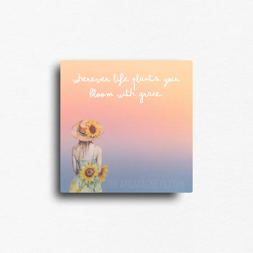 Fridge magnet with a woman holding sunflowers and text 'wherever life plants you, bloom with grace' on a gradient background.