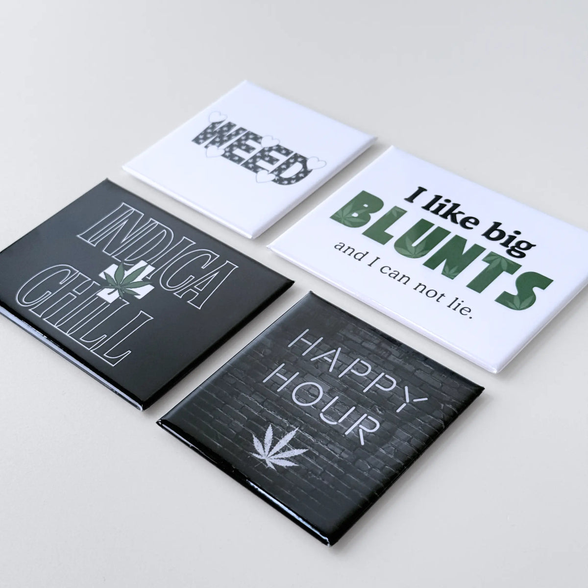 Cannabis novelty fridge magnets with 420 themed designs, square and rectangle magnets displayed as a bold home decor collection for ganja friendly homes.