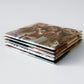 Custom photo magnets stacked closed up to show thickness, quality, and detail. Professional quality photos turned into picture magnets you can gift or use to personalize your space.