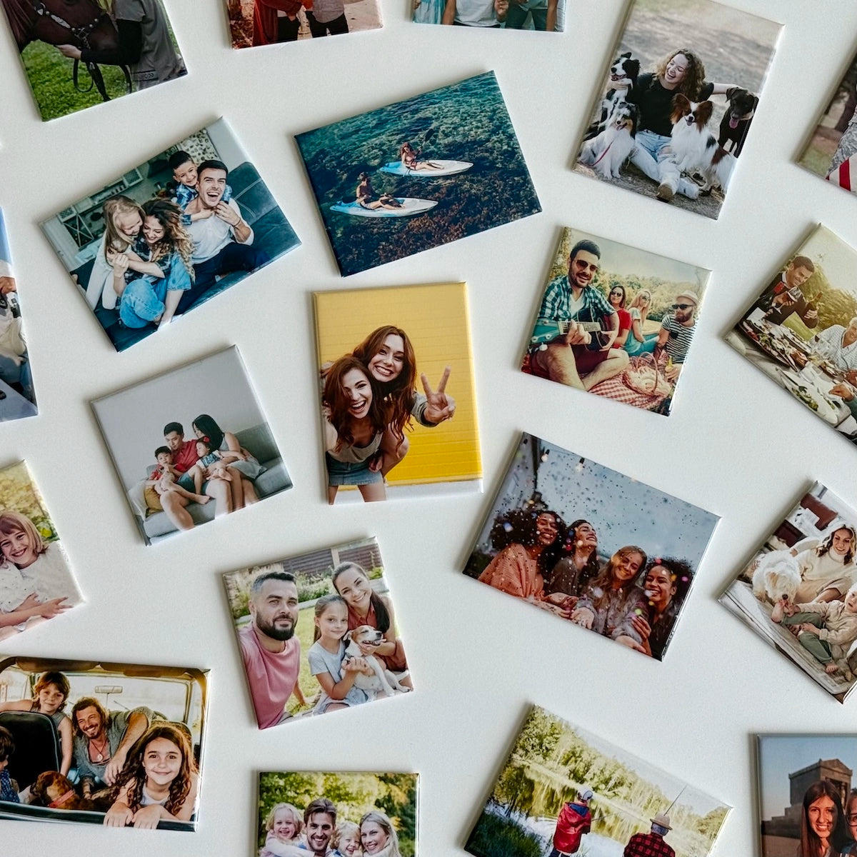 Custom photo magnets featuring diverse moments of family, friendship, pets, and celebration, displayed on a white surface as personalized keepsakes and thoughtful gifts