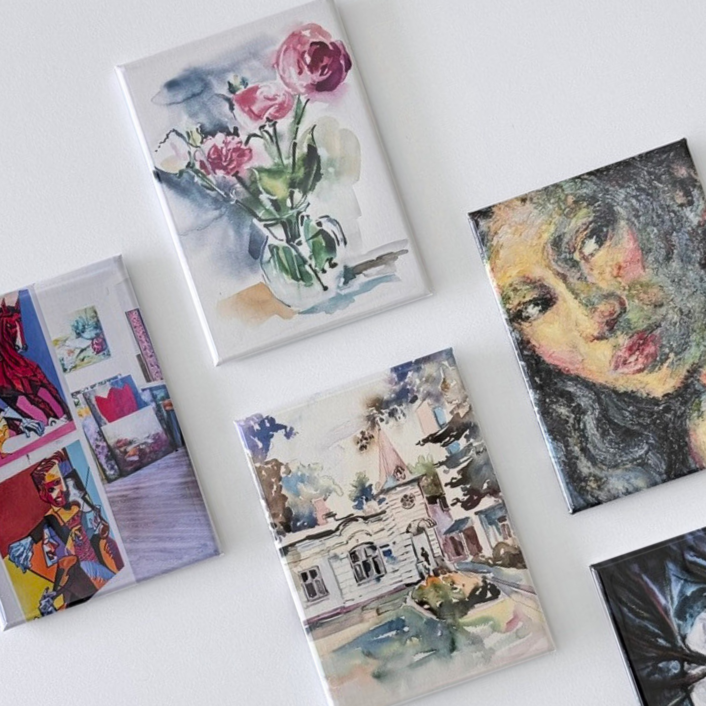 Mini magnetic art prints displayed as button magnets featuring watercolor and illustrated artwork, ideal for client gifts or retail sales.
