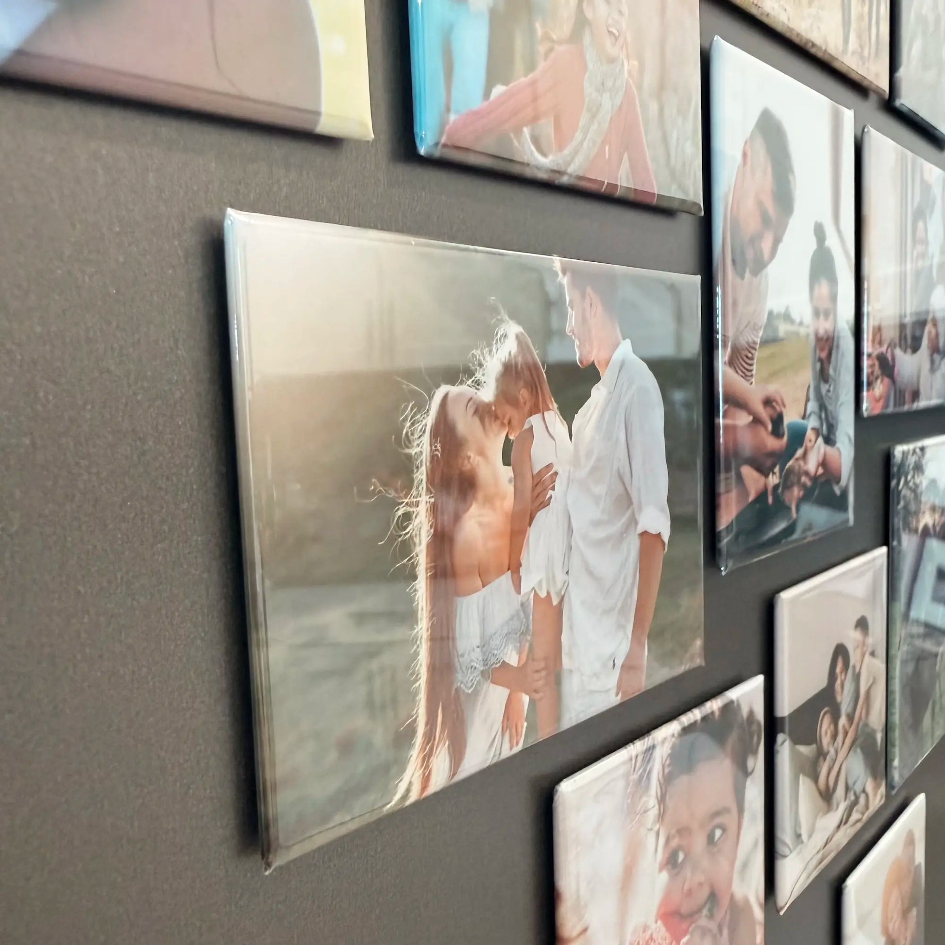 Custom photo magnets in close-up side view on a fridge, showing family images as a personalized magnetic photo display and keepsake