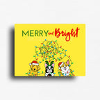 Funny holiday fridge decor magnet featuring a happy yellow background and three dogs tangled in christmas lights. 