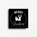 Simple black fridge magnet with a 'merry christmas' message and a deer with trees. Kitchen decor or small gift for christmas. 