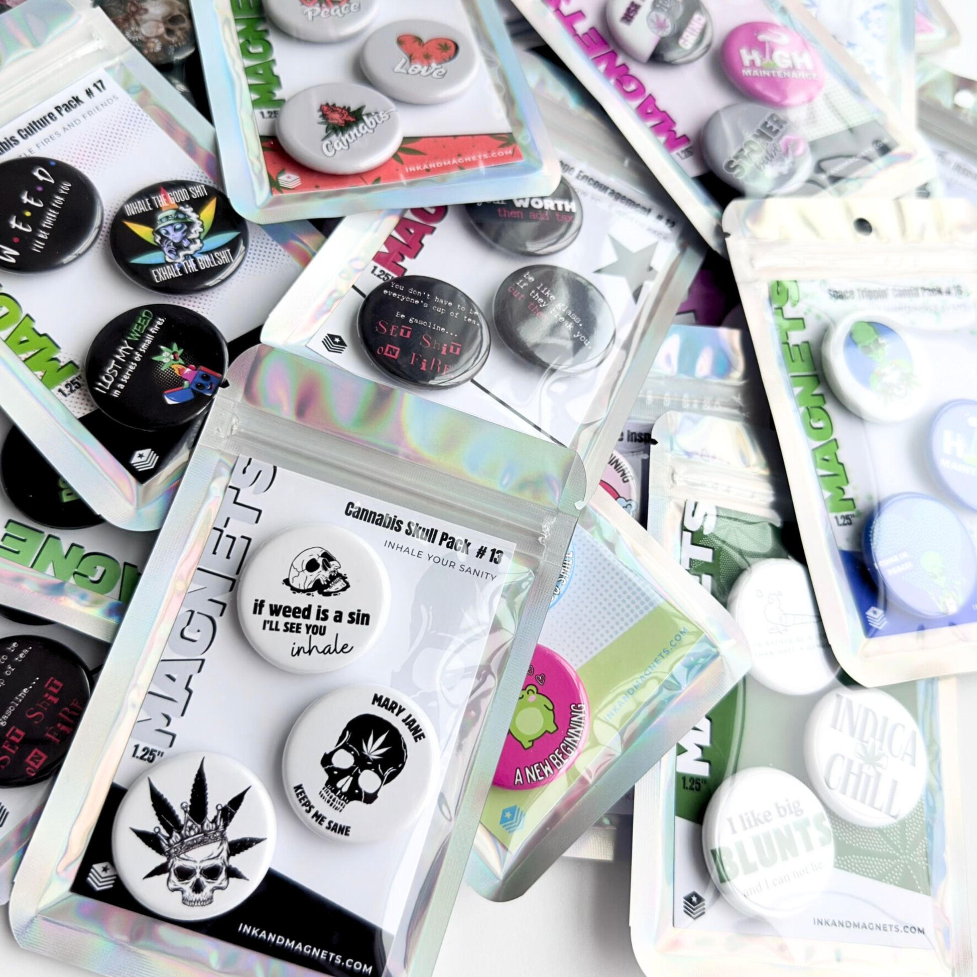 Assorted button magnet packs with novelty and cannabis themed designs, showing a variety of fun fridge magnets and packaging styles.