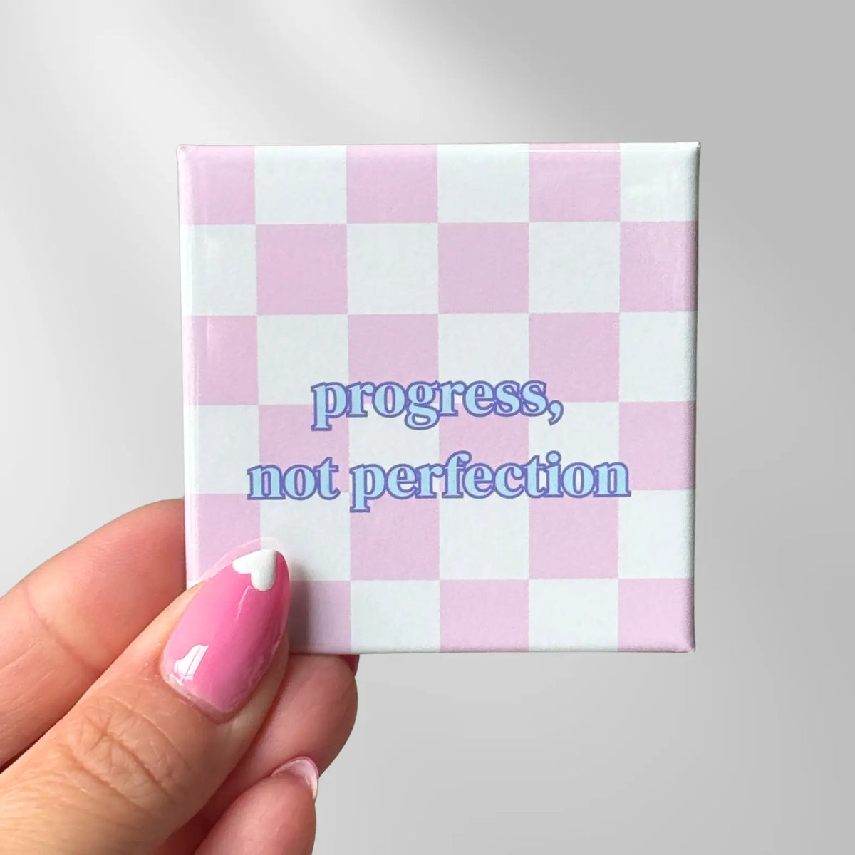 Encouragement magnet with Progress, Not Perfection quote on a pink checkered background. Great for kids locker gifts, and maximalist decor.