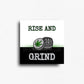 Cannabis culture, rise and grind magnet with green text and cannabis grinder illustration on white and black background, square novelty fridge magnet