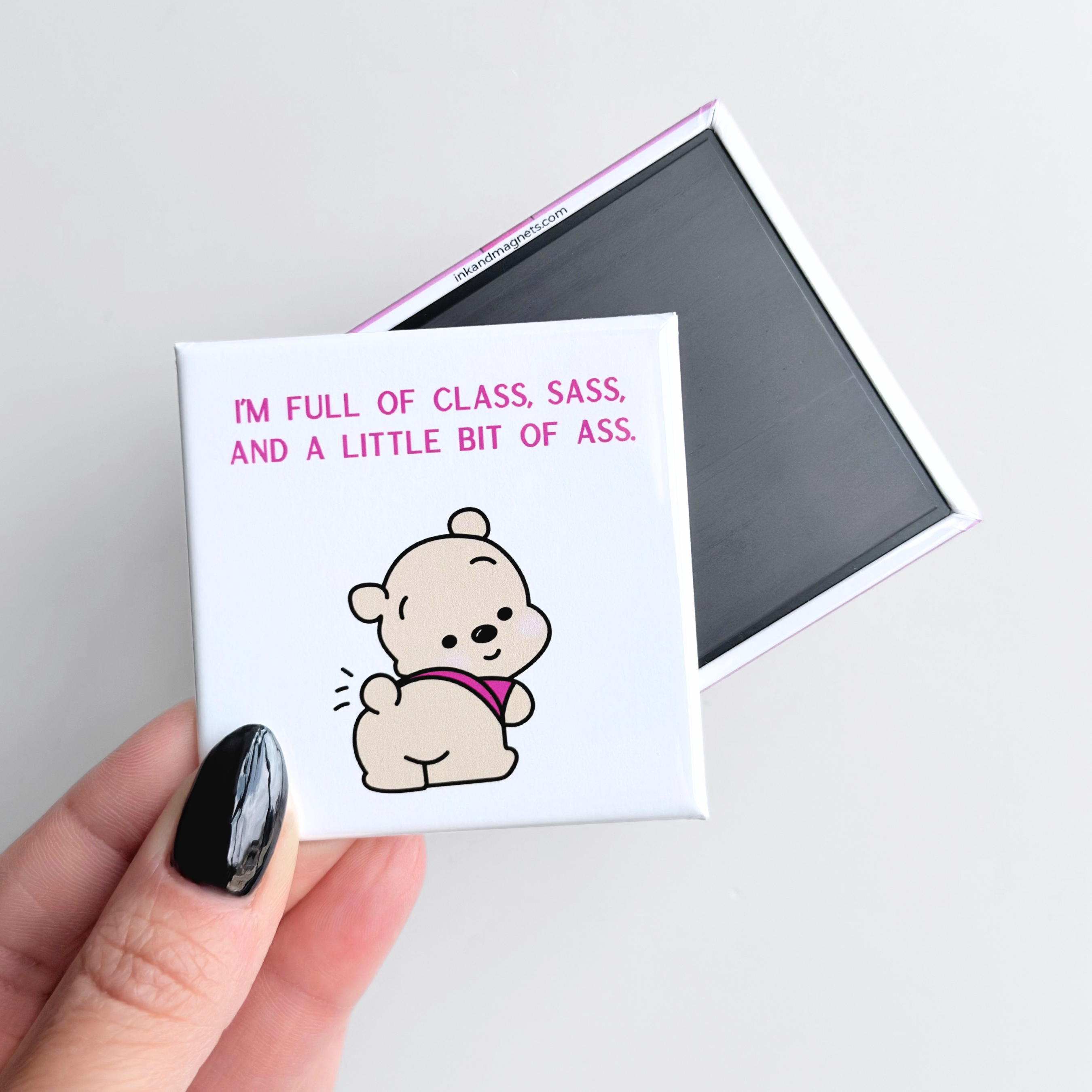 Funny novelty fridge magnet for girls with sass, with a cartoon bear and text held by a hand on a light gray background.