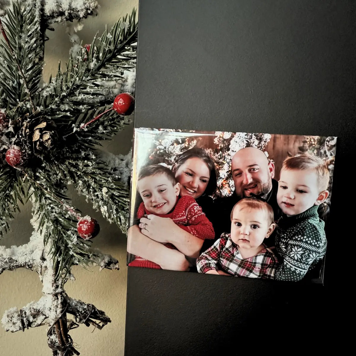 Custom photo magnet styled with a cozy holiday family portrait, shown as a meaningful stocking stuffer and heartfelt keepsake for gifting and seasonal décor.