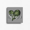 Novelty fridge magnet with heart-shaped design with cannabis leaves and 'Stoner' text on a gray background, custom square button magnet and design by ink and magnets available for wholesale orders.
